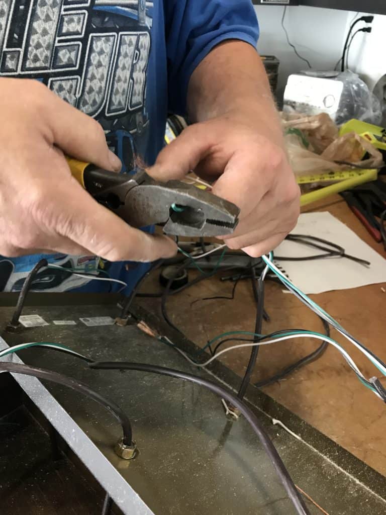 clipping the ends of the wires to attach them for the planter box chandelier